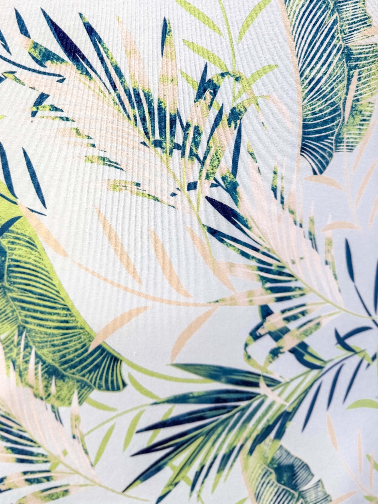 Tropical leaf pattern with green, blue, and beige leaves on a light blue background, Light Blue Leaves print by Latte Love