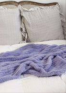 Lavender plush blanket Lounge by Jan Marie Bed with gray pillows and a purple blanket on a white background