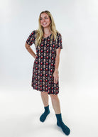 Merry Mugs V-Neck Bamboo Nightshirt featuring a whimsical holiday print, modeled by a woman standing with a cheerful expression.