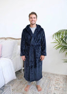 Long Navy Hooded Fleece Robe on male model in bedroom setting front view - Cloud Nine Pajamas
