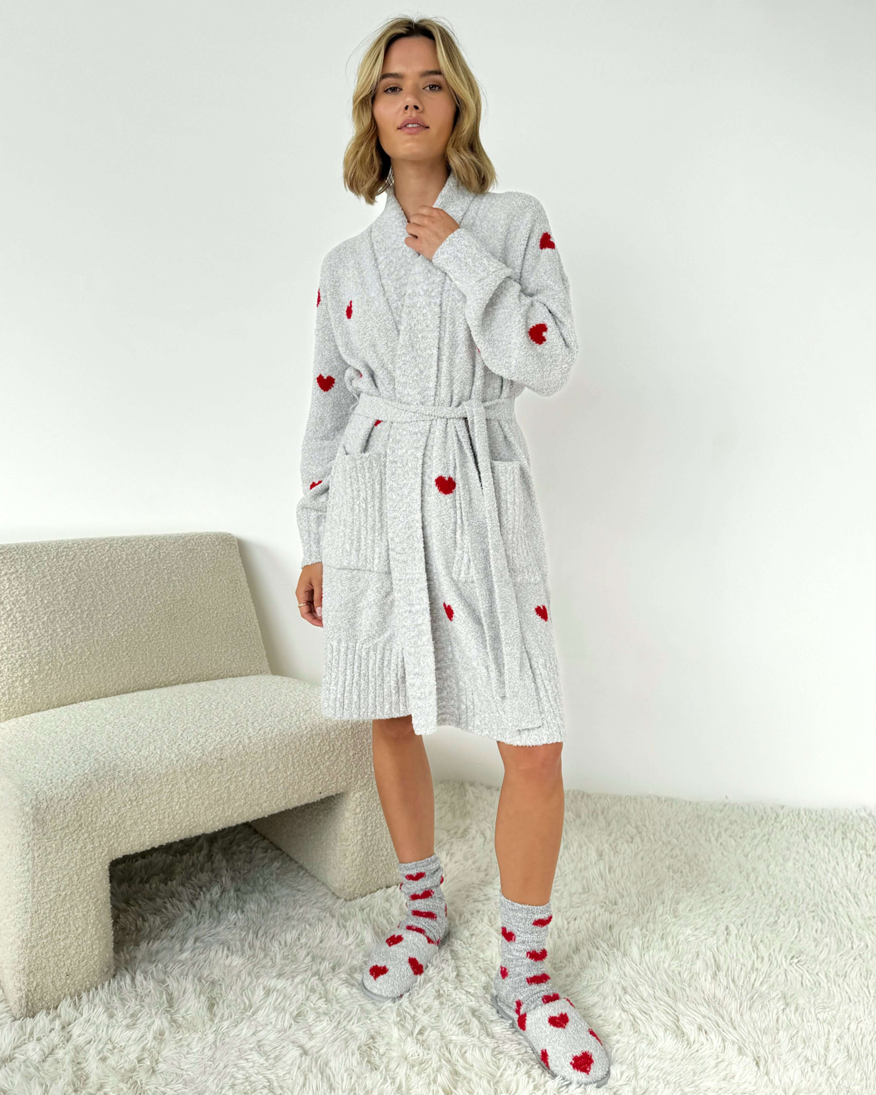 Model wearing the Pomona Fuzzy Yarn Robe Splendid in gray with red hearts, showing length of robe standing