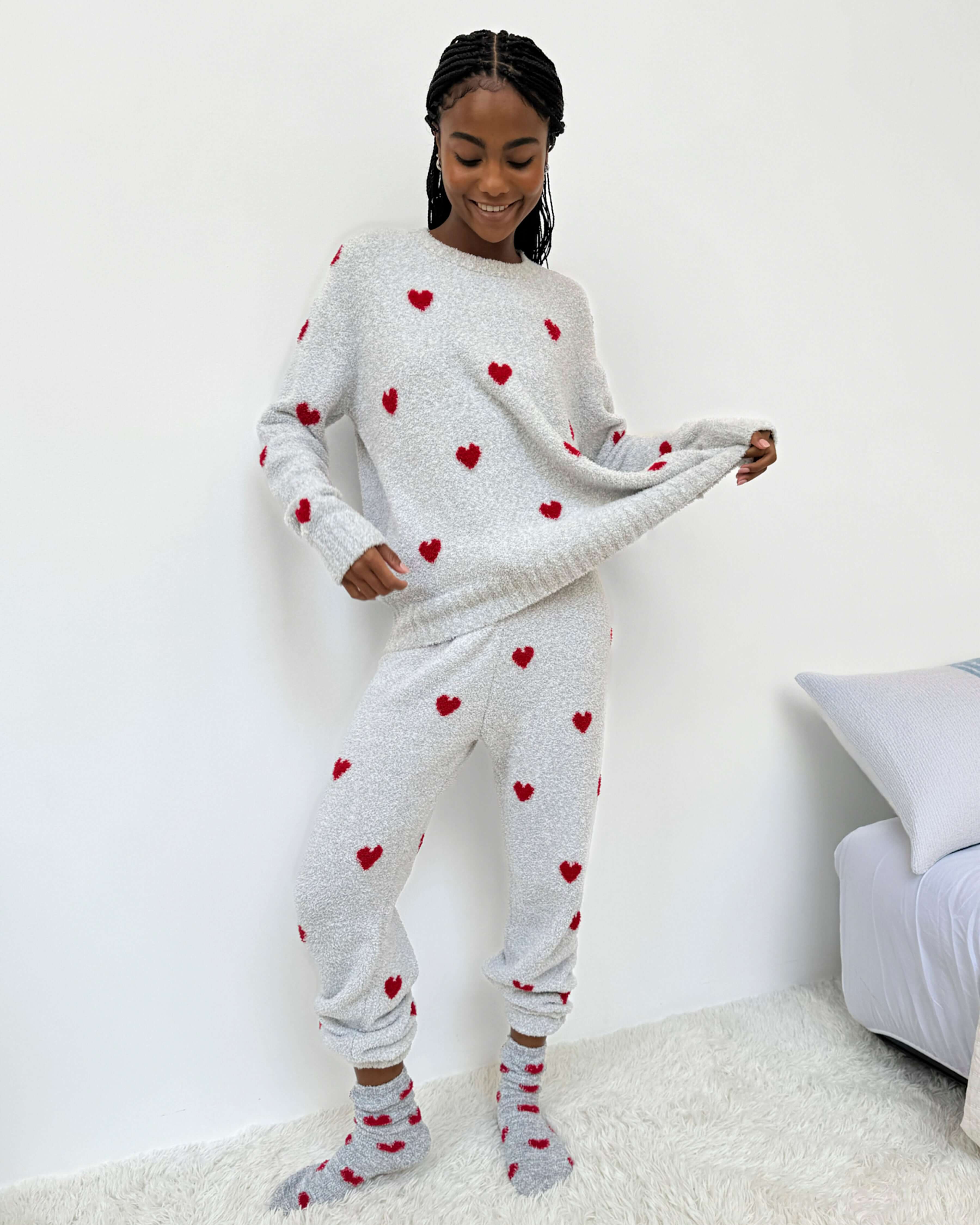 Woman wearing Cloud-Soft Fuzzy Sweater Pajama Set Splendid with heart patterns, showcasing cozy loungewear style.