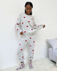Woman wearing Cloud-Soft Fuzzy Sweater Pajama Set Splendid with heart patterns, showcasing cozy loungewear style.