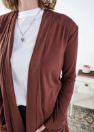 Person wearing a brown cardigan over a white shirt with a blurred background Scarlett Ellie Summer Open Lightweight Cardigan | Cloud Nine Pajamas