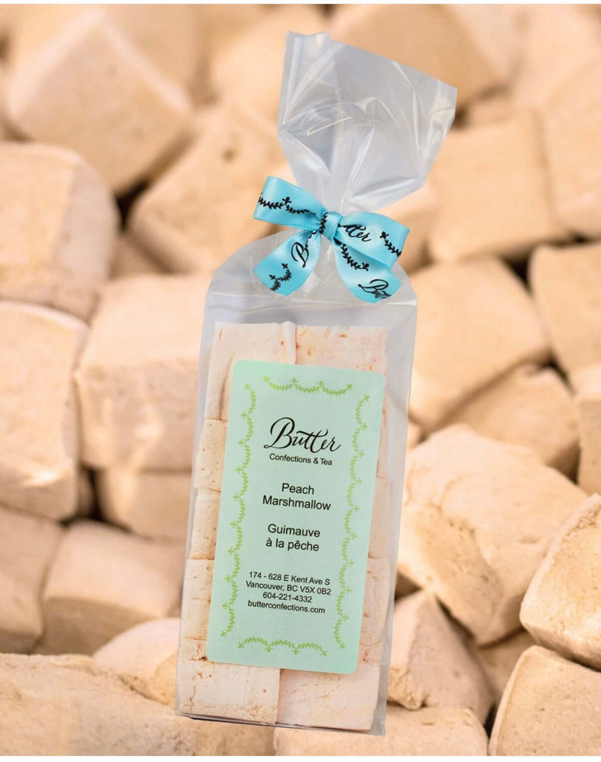Handcrafted Gourmet Marshmallows in a clear bag with peach flavor and decorative ribbon, perfect for indulging.