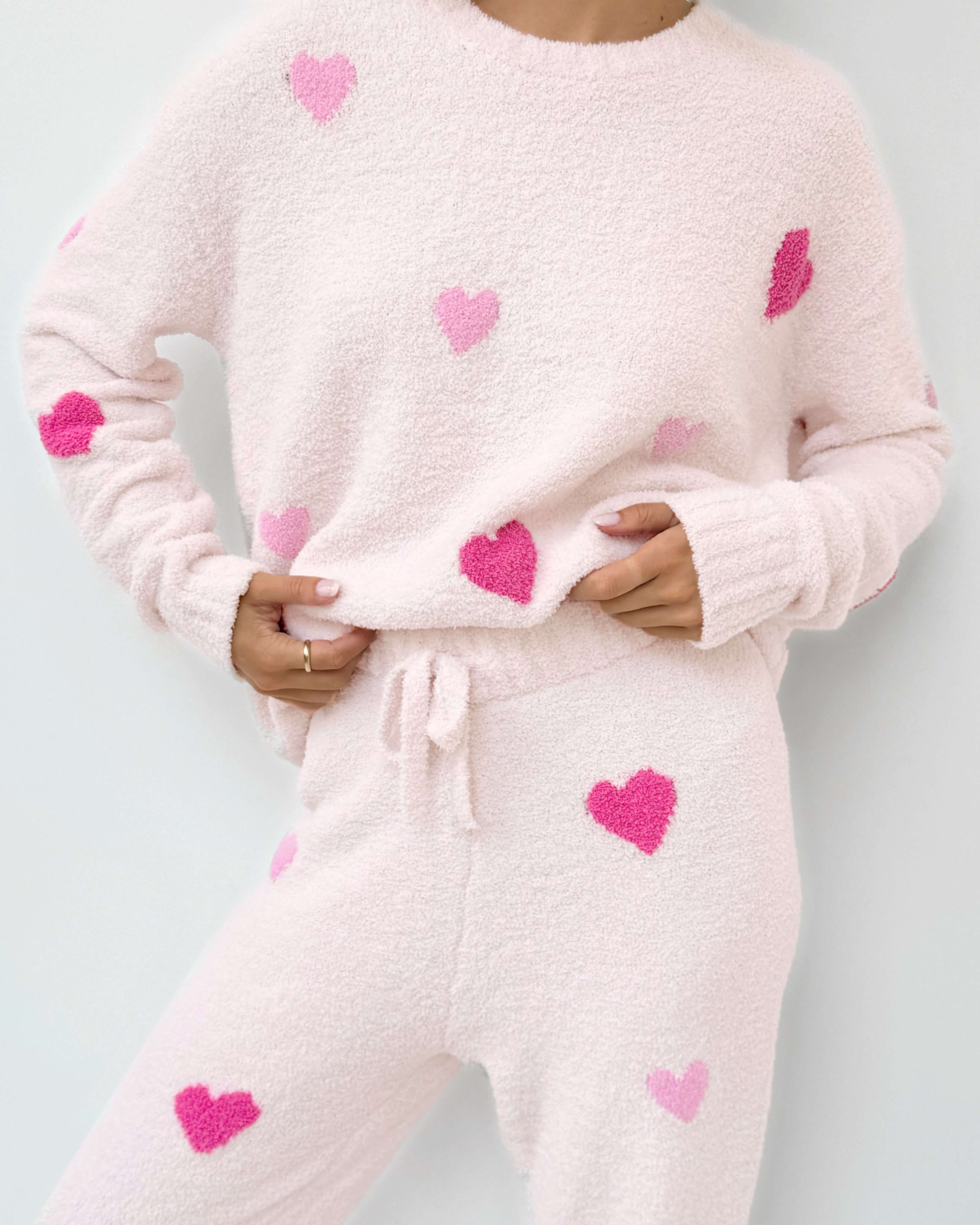 Cloud-Soft Fuzzy Sweater Pajama Set Splendid in soft pink with heart patterns, perfect for cozy loungewear. close up of print and fabric