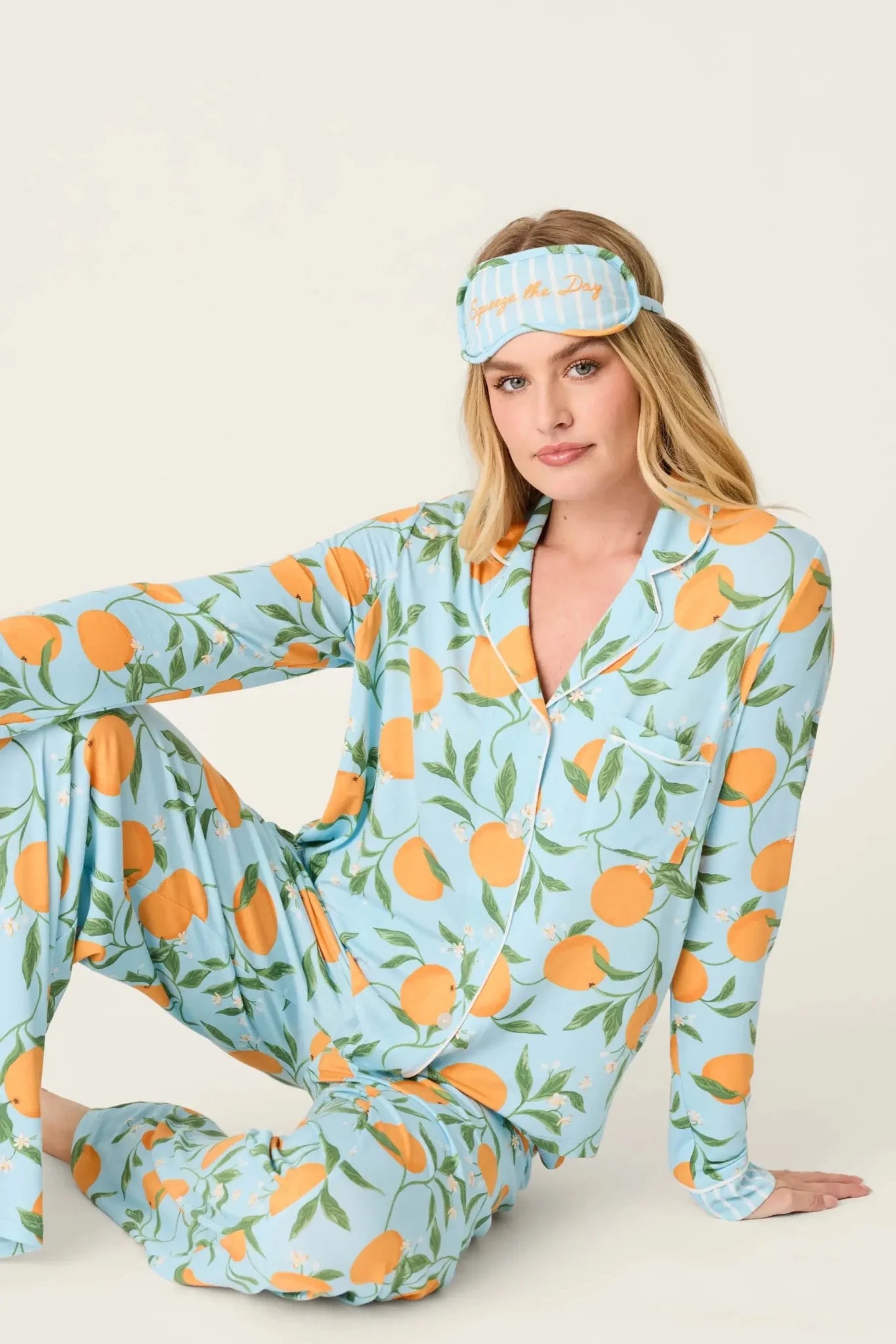 Model wearing PJ Salvage Citrus Dreams 3-Piece PJ Set featuring orange design with matching eye mask.