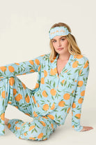 Model wearing PJ Salvage Citrus Dreams 3-Piece PJ Set featuring orange design with matching eye mask.