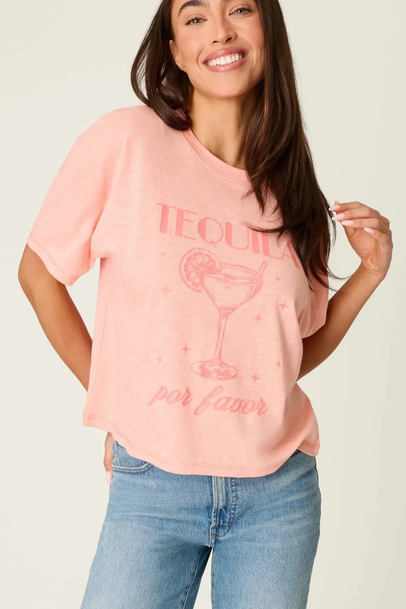 Model wearing PJ Salvage Paloma Mama "Tequila Por Favor" Graphic Tee in light pink with a cocktail graphic.