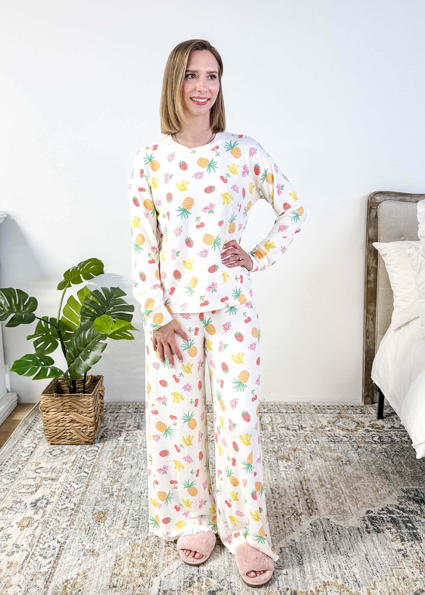 PJ SALVAGE — Viva la Vida Fruit Fiesta Long Sleeve & Pant Set worn on model in a bedroom setting, showing full length of the fruit print pj set