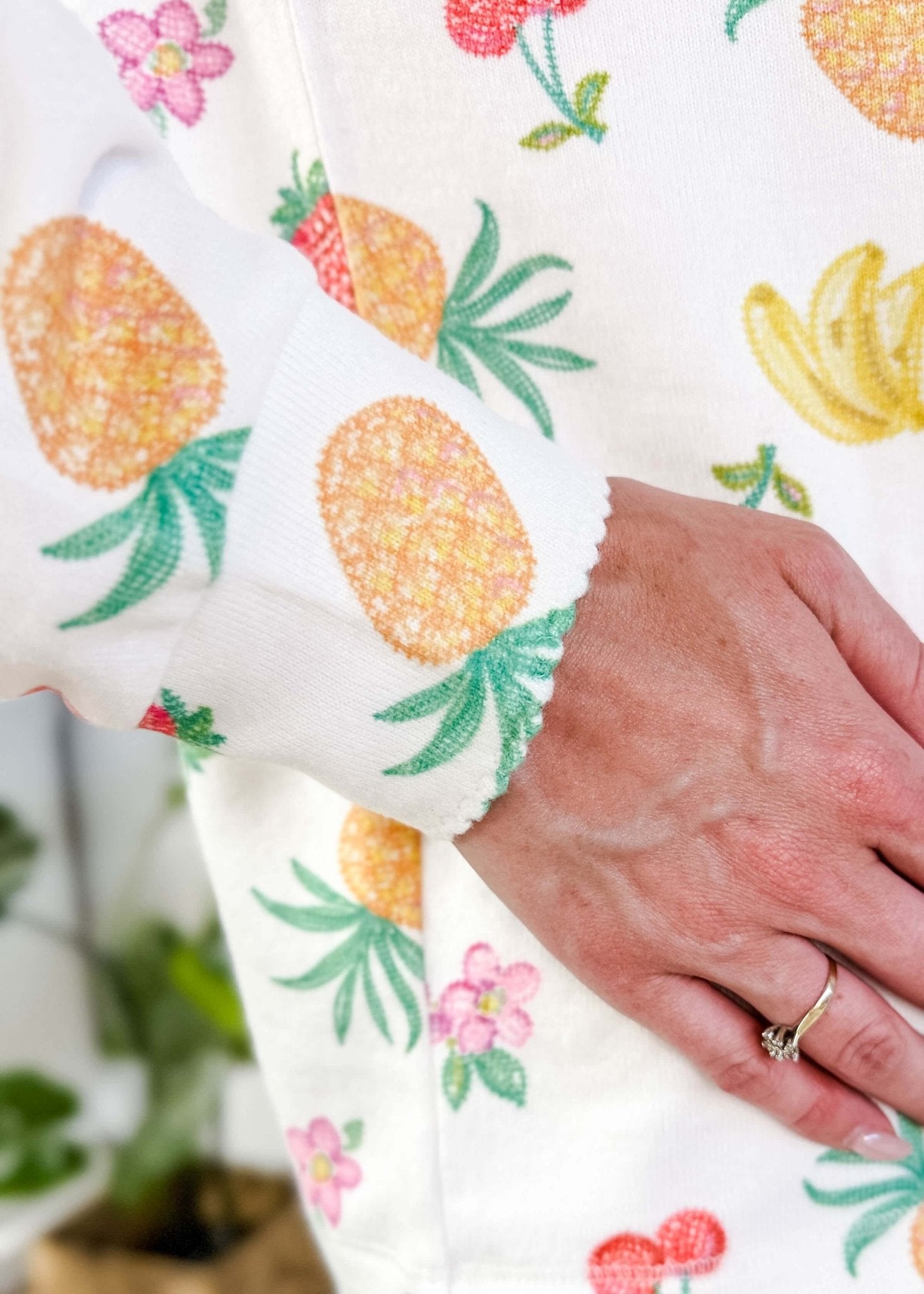 PJ SALVAGE — Viva la Vida Fruit Fiesta Long Sleeve & Pant Set worn on model in a bedroom setting, close up of scalloped detail on cuff of the long sleeve top