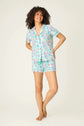 Model showcasing PJ Salvage Whimsy Button Up & Short Short Set in colorful prints.