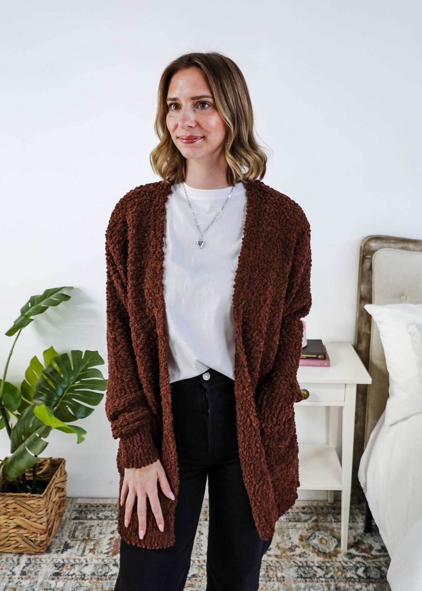 Woman wearing a brown cardigan with texture  in a bedroom setting, Popcorn Texture Open Summer Cardigan in a chocolate brown