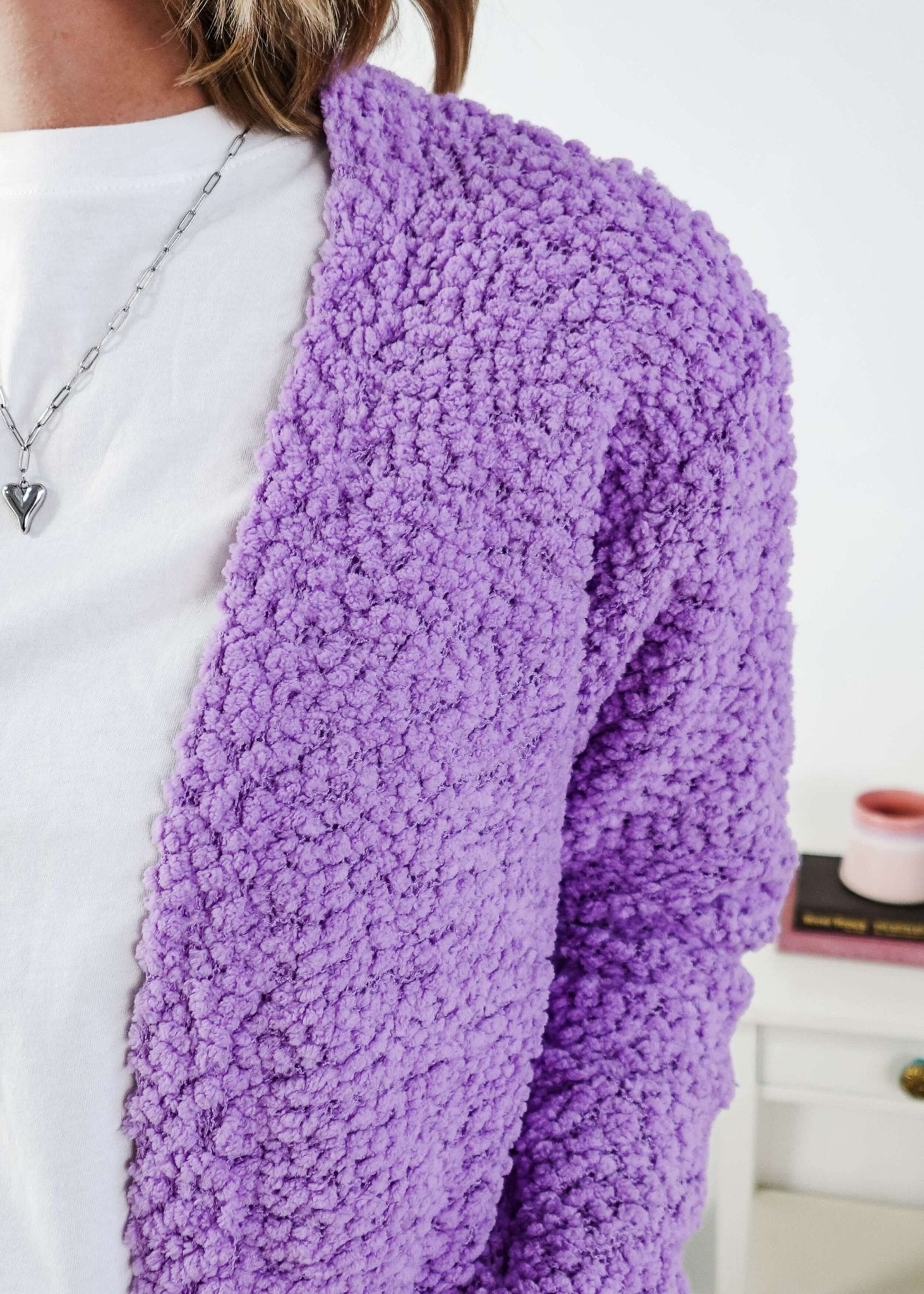 Popcorn Texture Open Summer Cardigan Woman wearing a light purple  cardigan with texture  in a bedroom setting, showing texture of the fluffy knit