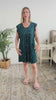 Women standing in bedroom showing her nightgown. The night dress is just above the knees with a flowy fit and pleating. The nightgown has little white hearts. 