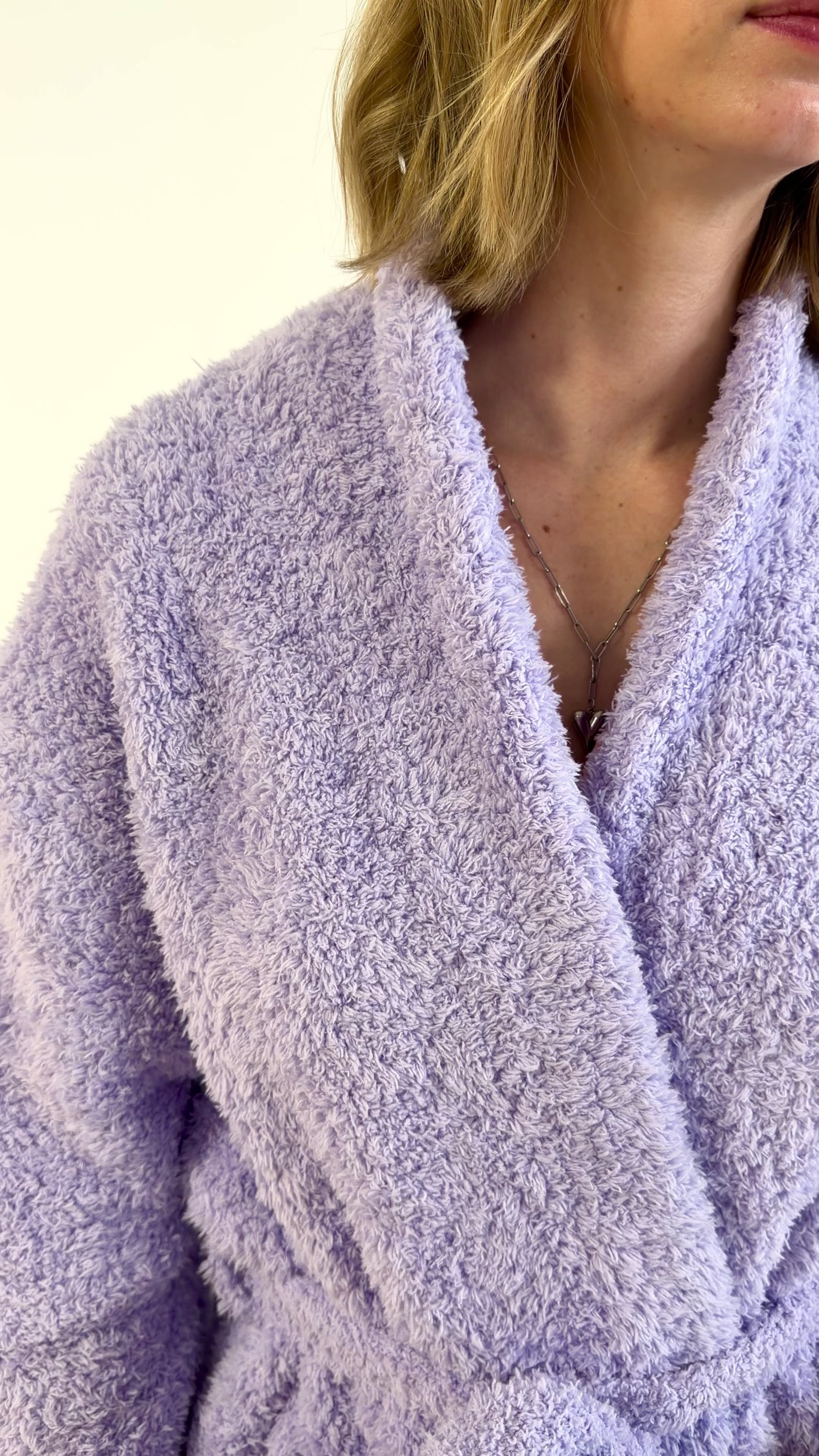 slow pan of the lavender cloud spa robe on model, showing texture, length and pocket details. 