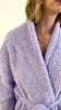 slow pan of the lavender cloud spa robe on model, showing texture, length and pocket details. 