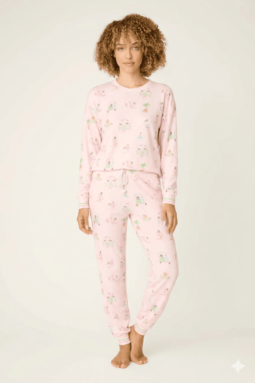 Model wearing Pupcation Palms Sunnies & Sunshine Dog Print Jogger Set by PJ Salvage in pink with playful dog prints.