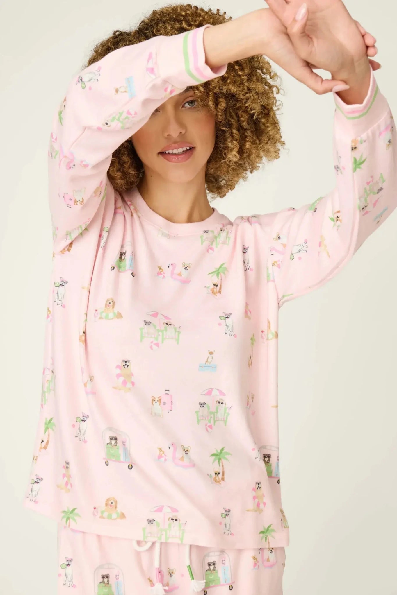 Pupcation Palms Sunnies & Sunshine Dog Print Jogger Set worn by model, showcasing playful dog prints on light pink fabric.