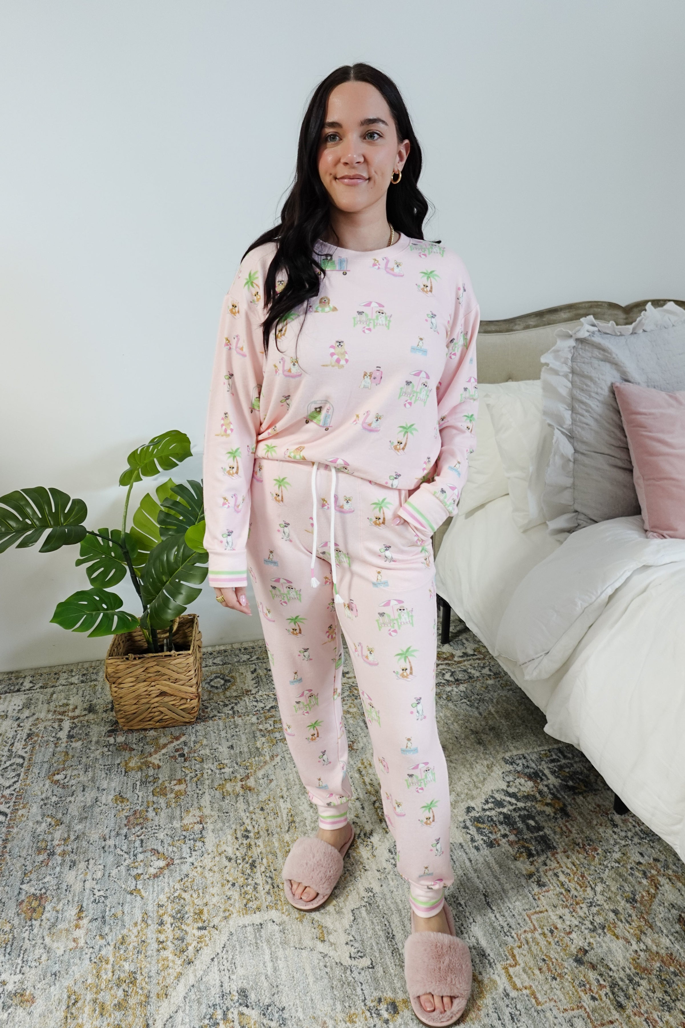 Model wearing Pupcation Palms Sunnies & Sunshine Dog Print Jogger Set by PJ Salvage in pink with playful dog prints.