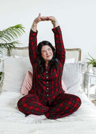woman stretching on bed wearing Red Plaid Button Up Bamboo PJ Set Straight Leg Pant 