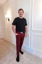 unisex joggers for men and women holiday red plaid print in soft bamboo fabric. Man wearing with classic black tee