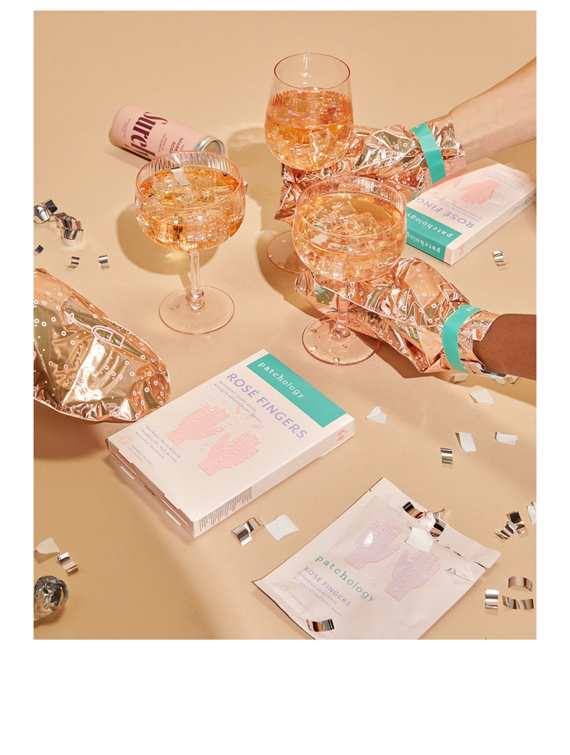 Glasses of rose wine with packaging on a beige surface, Patchology Rosé Fingers renewing hand mask rose gold gloves shea butter