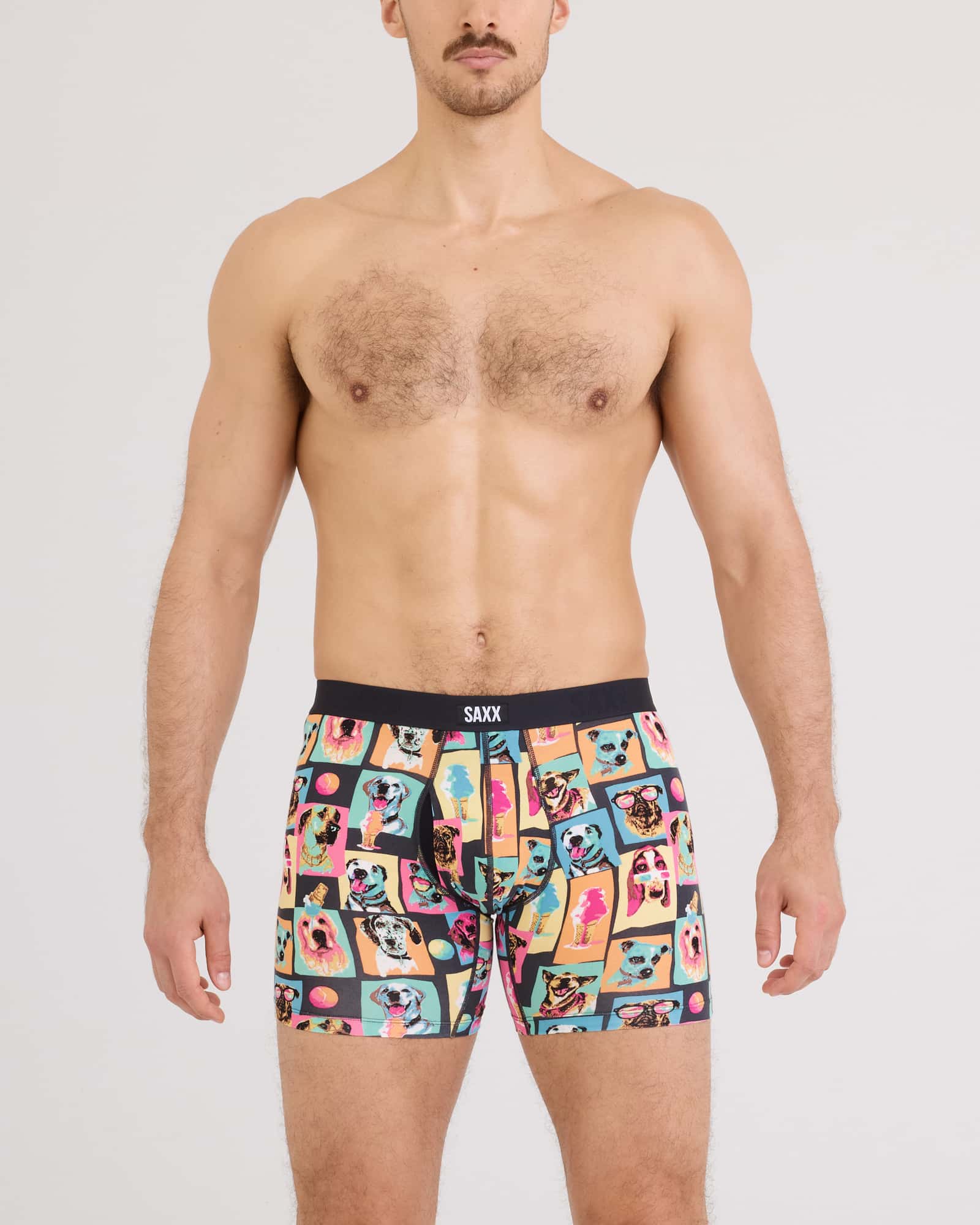 Model wearing Vibe Xtra Soft Comfort Boxer Brief in colorful fun designs by SAXX.