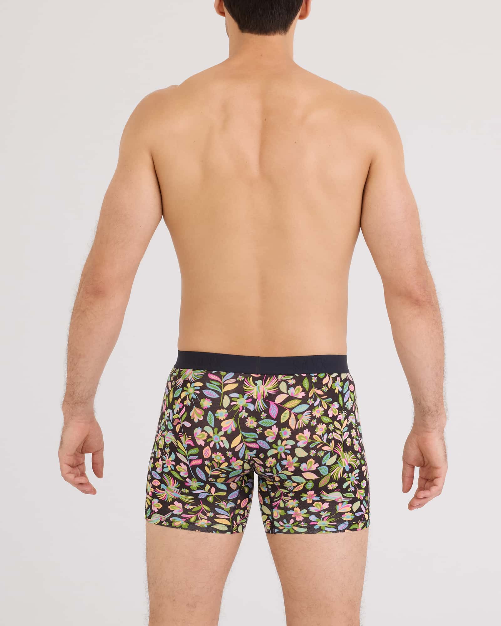 Back view of a man wearing SAXX Vibe Xtra Soft Comfort Boxer Brief in a vibrant floral print.