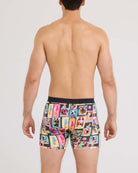 Back view of a man wearing Vibe Xtra Soft Comfort Boxer Brief featuring colorful dog prints.