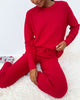 Woman wearing Cloud-Soft Fuzzy Sweater Pajama Set Splendid in vibrant red, showcasing ultimate comfort and style.