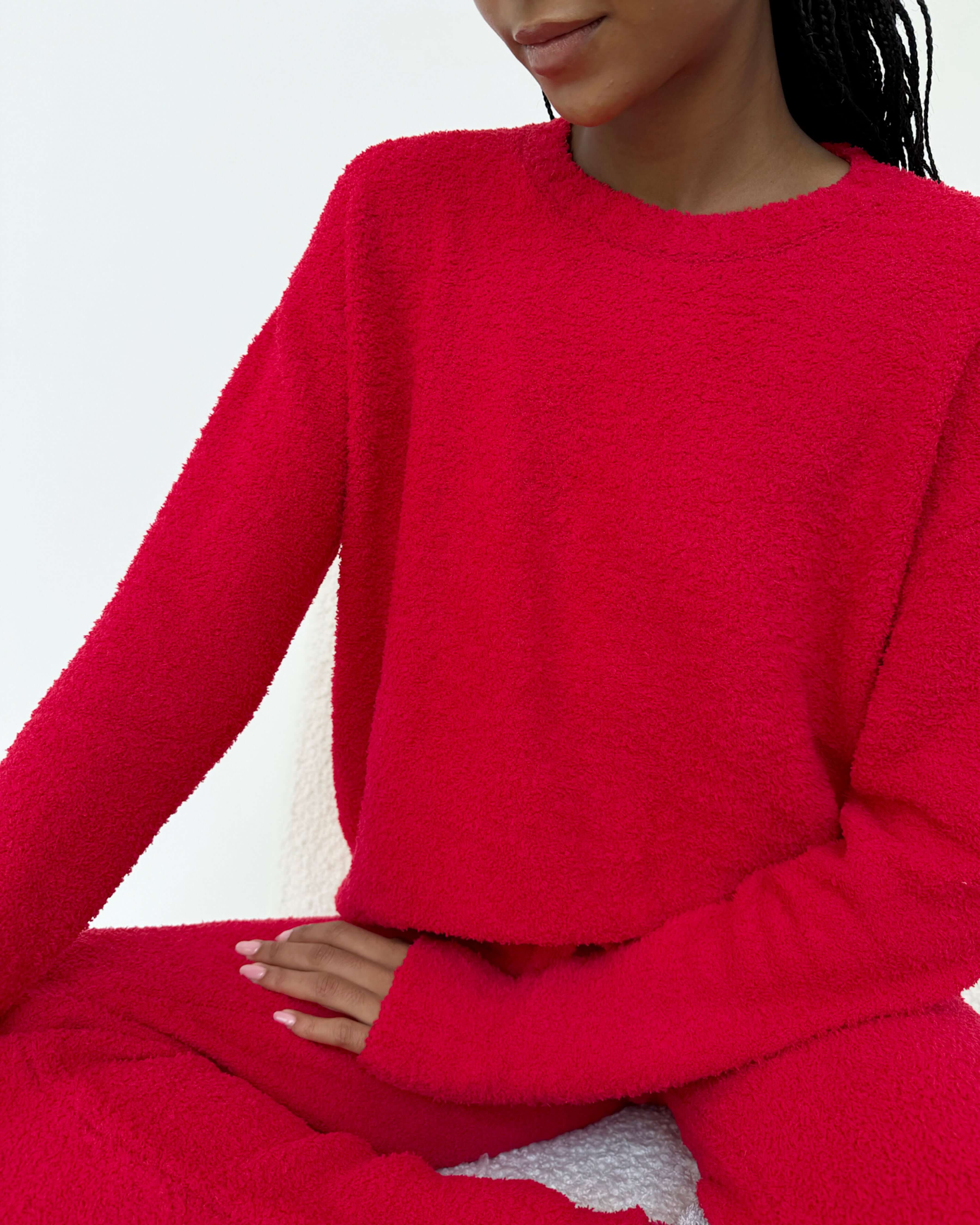 Woman wearing Cloud-Soft Fuzzy Sweater Pajama Set Splendid in vibrant red, showcasing ultimate comfort and style. close up of fabric and vibrant red colour