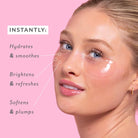 Woman's face with skincare product application on a pink background, showing text benefits. Patchology Serve Chilled Rosé Eye Gels 5 pack antioxidant hydrating