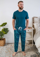 Shark Camo Blue Printed Jogger Sleep Pant in Bamboo for Men by Bob's Sleepwear Co - Cloud Nine Pajamas Worn by Model in Bedroom Setting