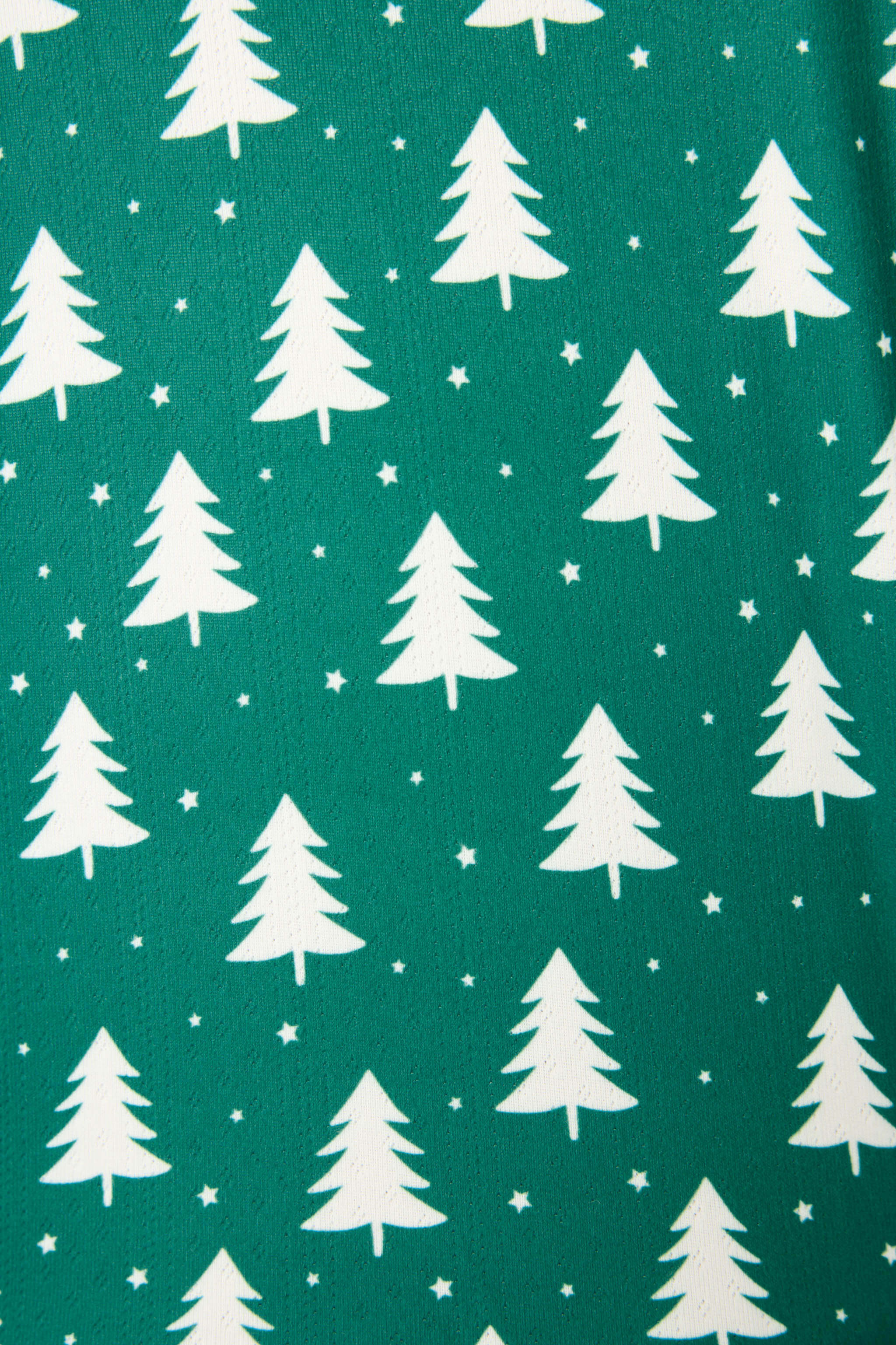 Pattern of white Christmas trees on a forest green background, perfect for the Silent Night PJ Set.