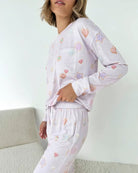 Model wearing Splendid Holiday Sugar Cookie Marna Pillowsoft PJ Set with colorful heart and star prints.