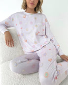 Model wearing Splendid Holiday Sugar Cookie Marna Pillowsoft PJ Set featuring playful holiday-themed prints.