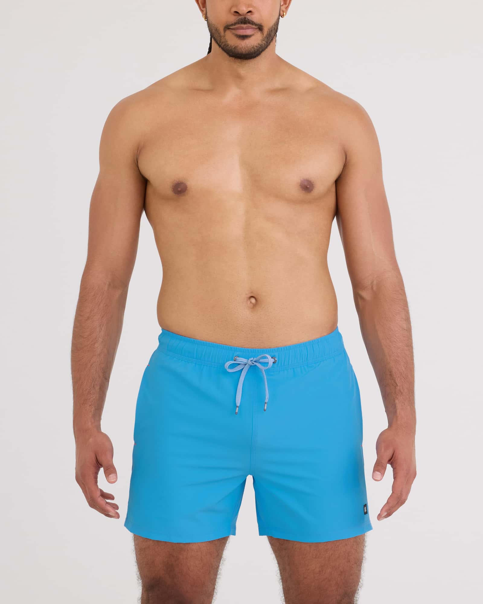 Model wearing Oh Buoy 2N1 Volley Swim Short 5" in vibrant blue color, showcasing a relaxed summer look.