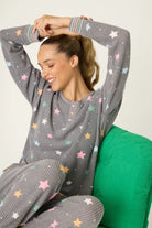 women's thermal waffle pj set with star print and charcoal grey background. Long sleeve top with buttons and Jogger bottoms by PJ Salvage