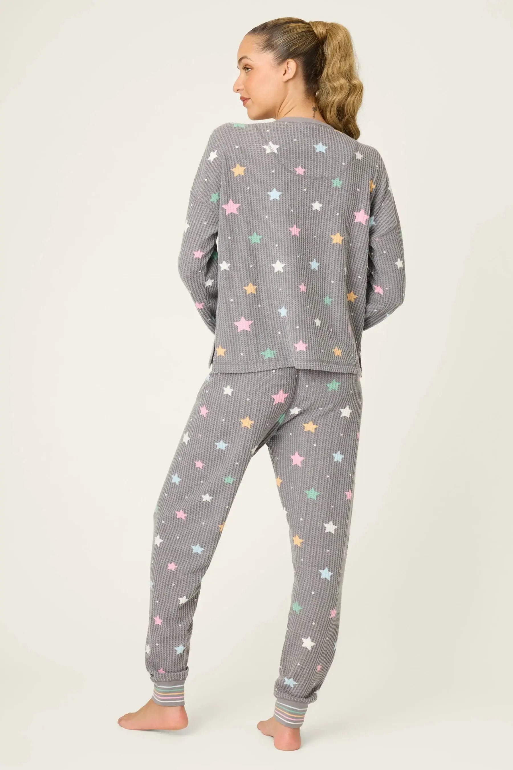 women's thermal waffle pj set with star print and charcoal grey background. Long sleeve top with buttons and Jogger bottoms by PJ Salvage