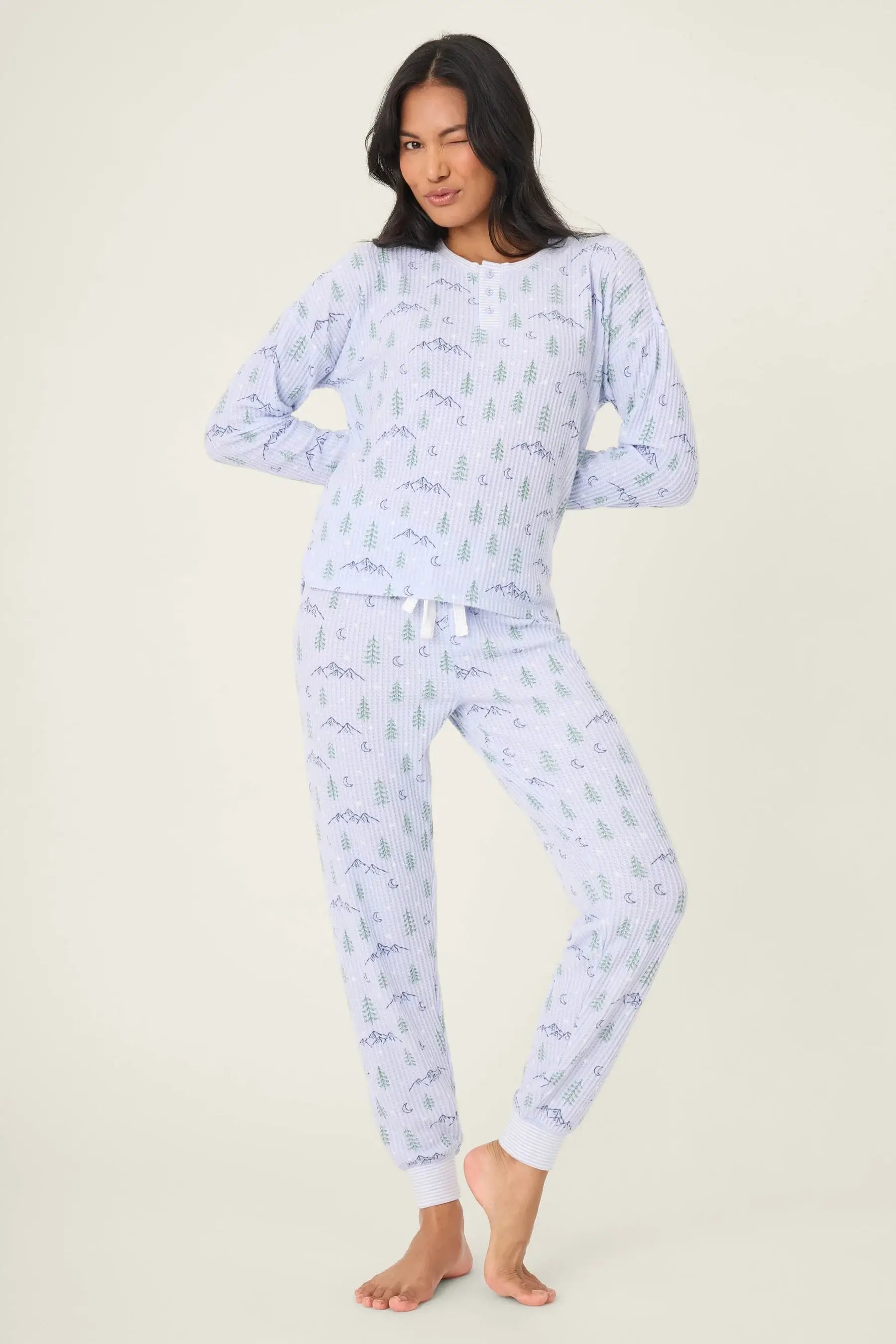 Mountain Dreams Thermal PJ Set worn by model, featuring long sleeve top and jogger bottoms with a cozy winter print.