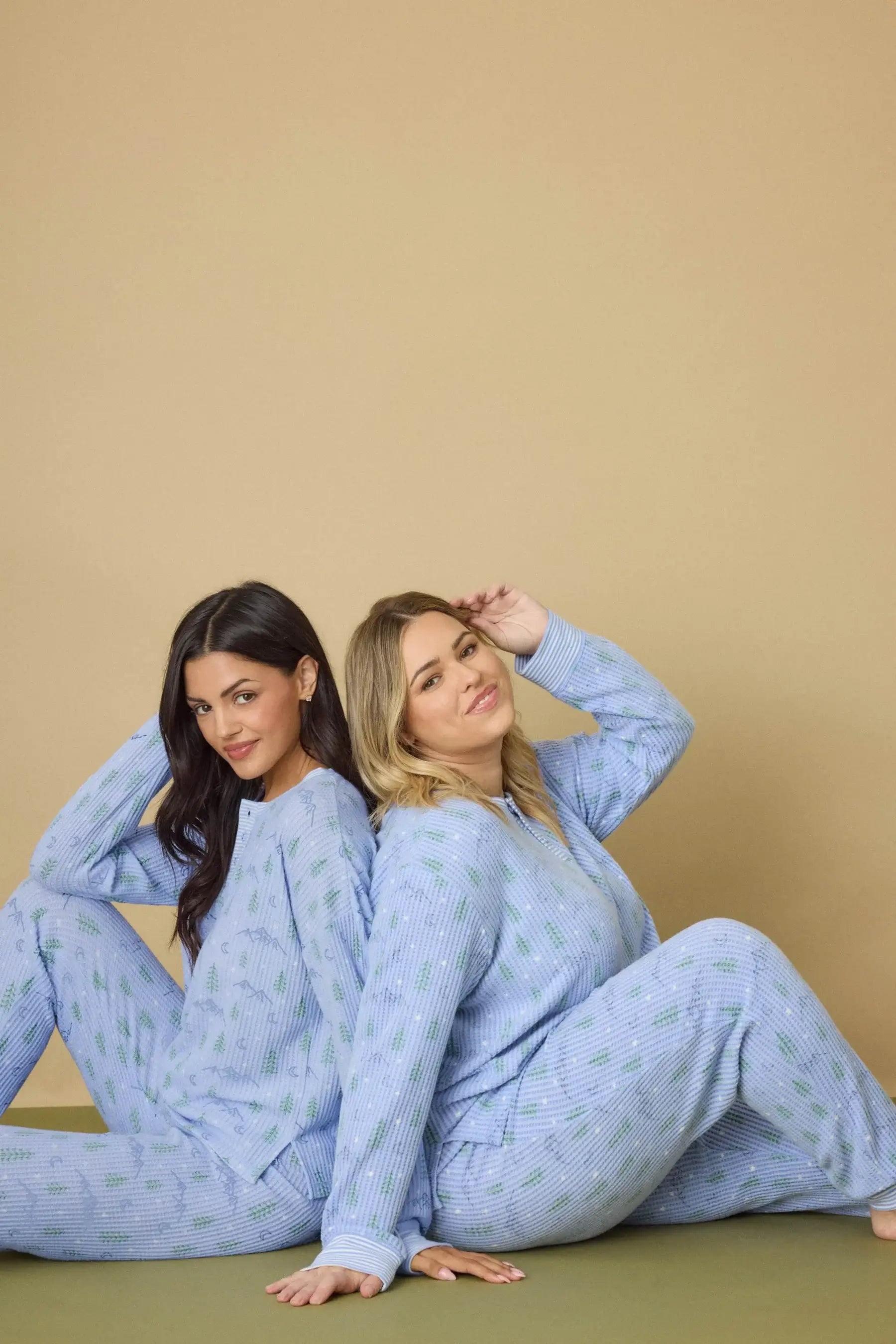 Two models wearing Mountain Dreams Thermal PJ Set by PJ Salvage, featuring long sleeves and joggers in a cozy setting.
