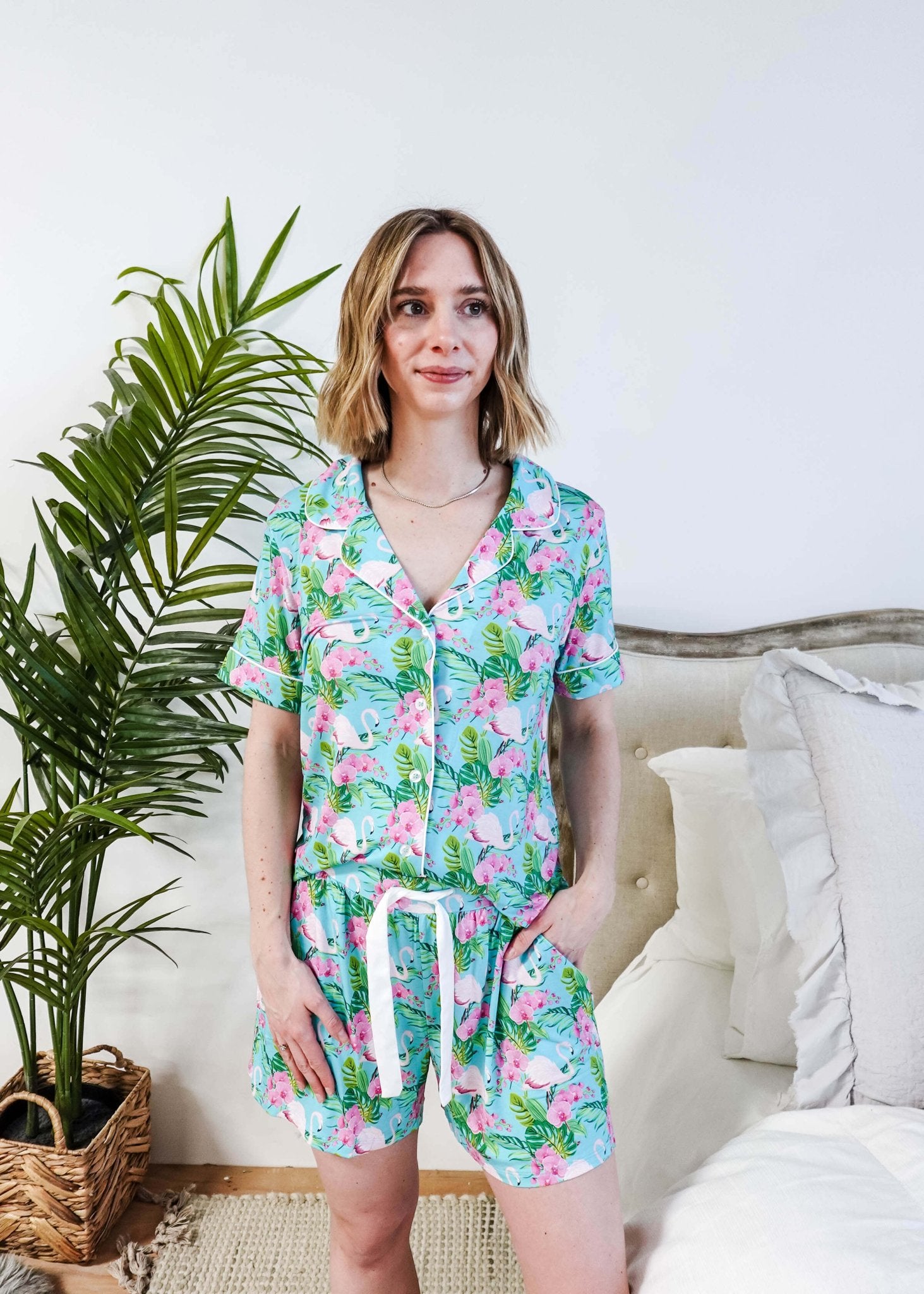 Tropic Like It's Hot Bamboo Short Sleeve Pajama Set worn by a model, featuring pink flamingos and tropical orchids.