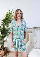 Tropic Like It's Hot Bamboo Short Sleeve Pajama Set worn by a model, featuring pink flamingos and tropical orchids.
