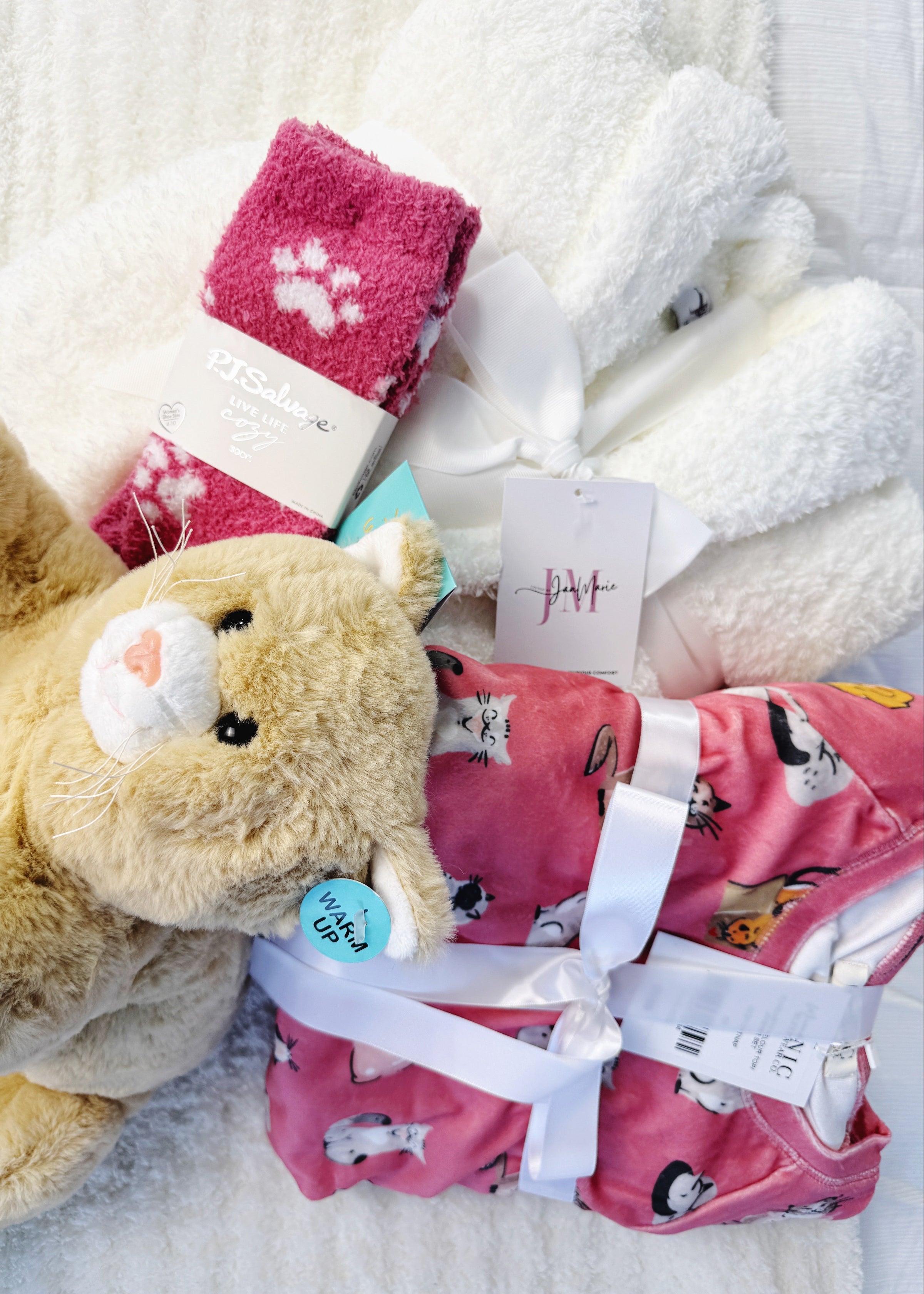 the Ultimate Cat Lover Gift Set, completley ready to wrap for anyone who loves kittys. Cat Print Pajamas, A plush white rove, socks and and a heating cat plush complete the gift set!