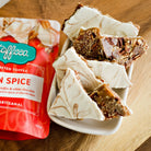 Utoffeea Canada Handcrafted Toffee with pumpkin spice flavor in a bowl next to its packaging.