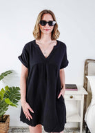 Woman wearing a black dress and sunglasses indoors with a plant and furniture in the background - Scarlett Ellie V-Neck Gauze Dress | Lightweight Summer Dress | Cloud Nine Pajamas