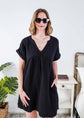 Woman wearing a black dress and sunglasses indoors with a plant and furniture in the background - Scarlett Ellie V-Neck Gauze Dress | Lightweight Summer Dress | Cloud Nine Pajamas