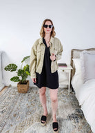 women in light weight gauze cotton black dress styled with a jean jacket. Scarlett Ellie V-Neck Gauze Dress | Lightweight Summer Dress | Cloud Nine Pajamas