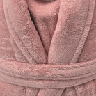 Close-up of a pink plush robe with texture details from warm buddy